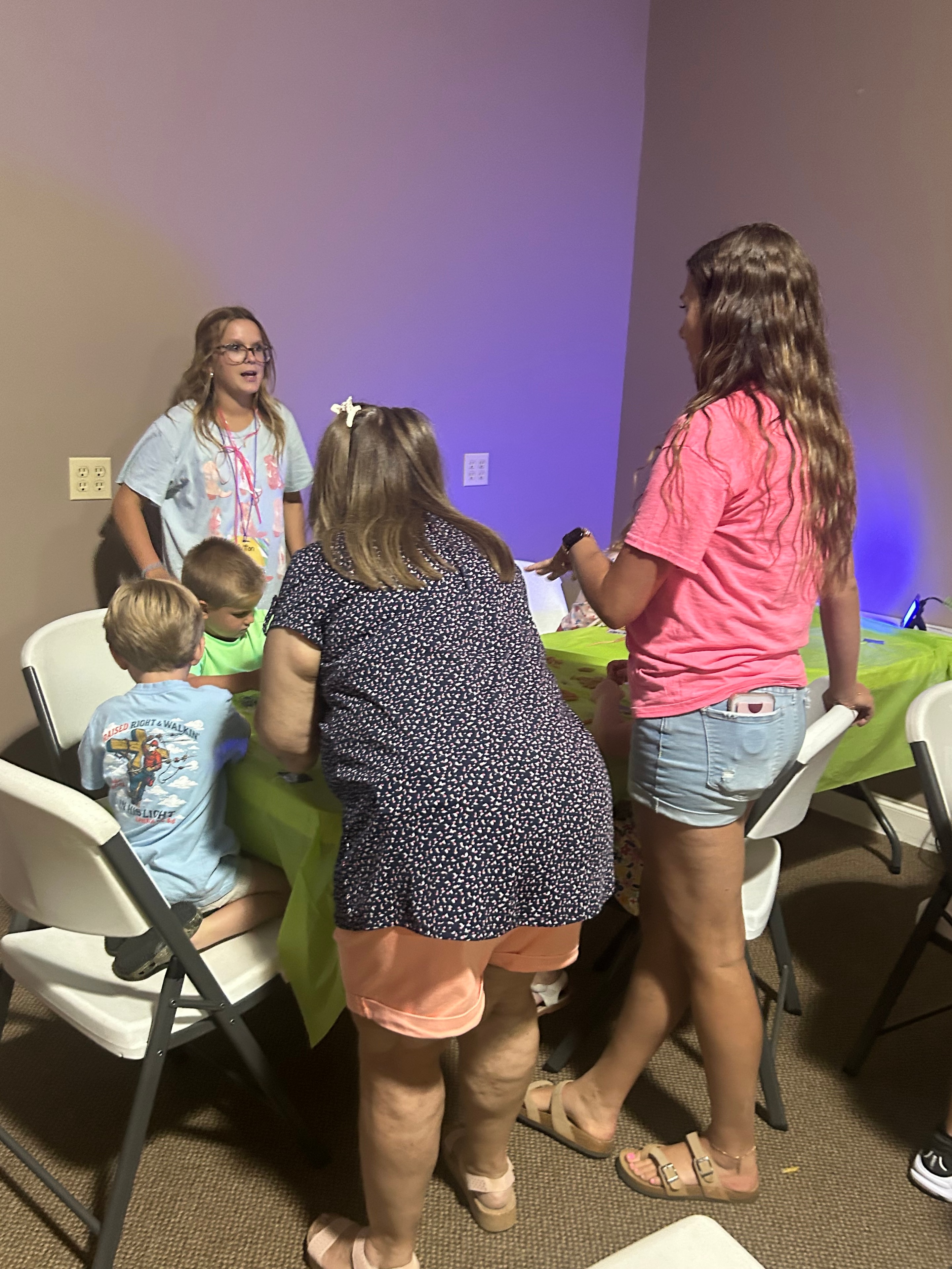 VBS volunteers and children gathered in a classroom activity