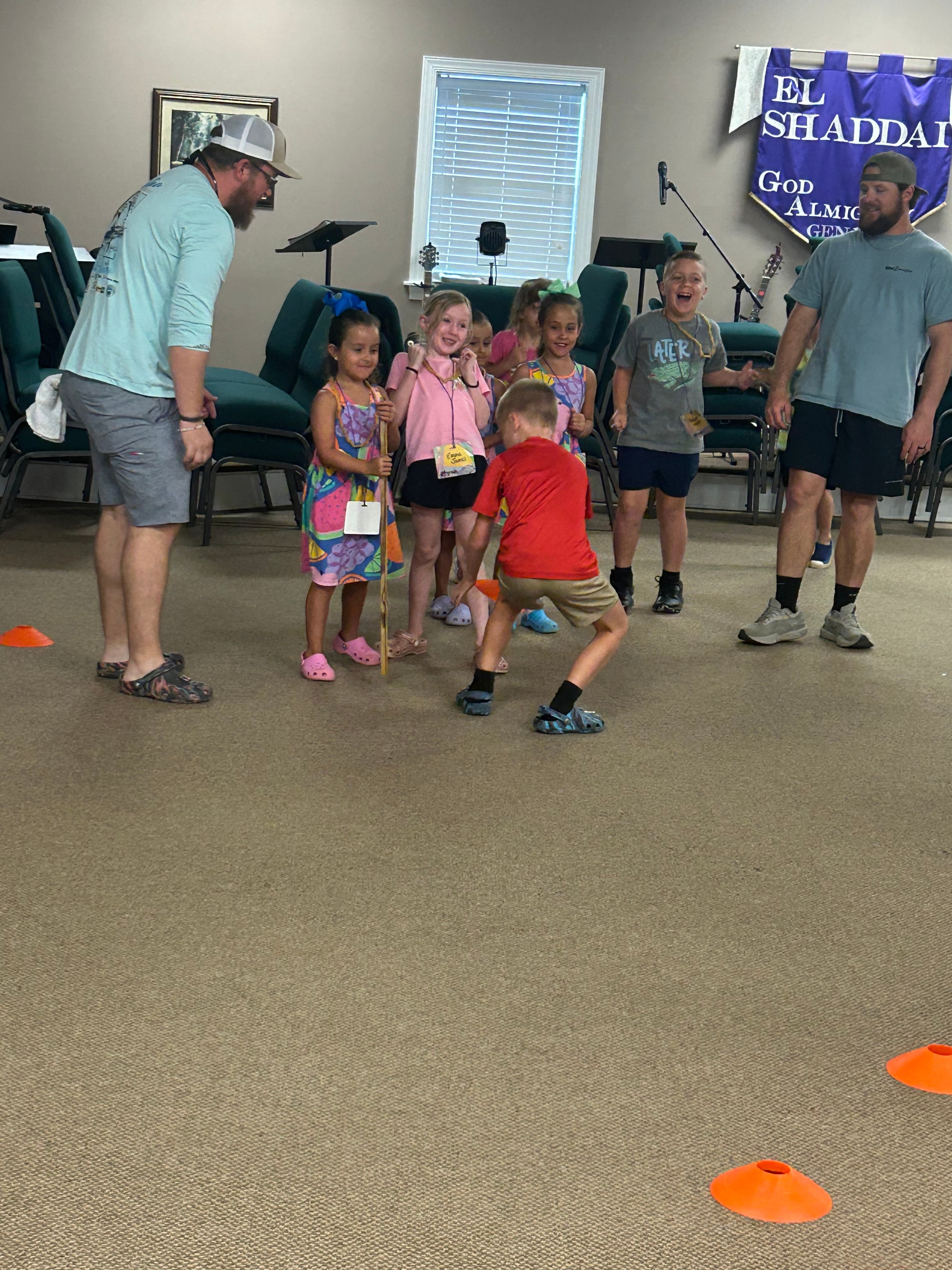 Children and leaders playing a game with orange cones at VBS 2026