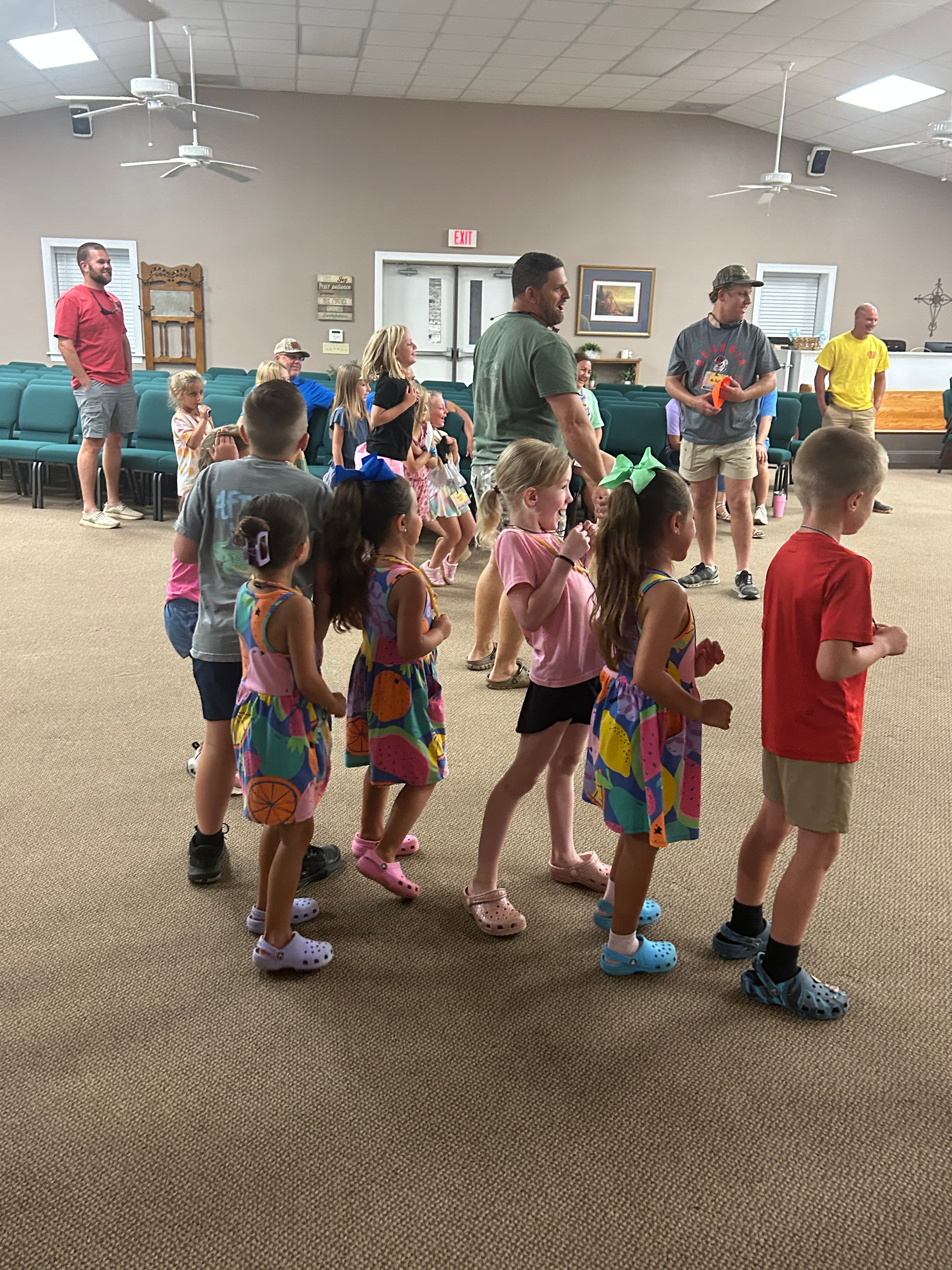 Children and volunteers active in a group game at VBS 2026