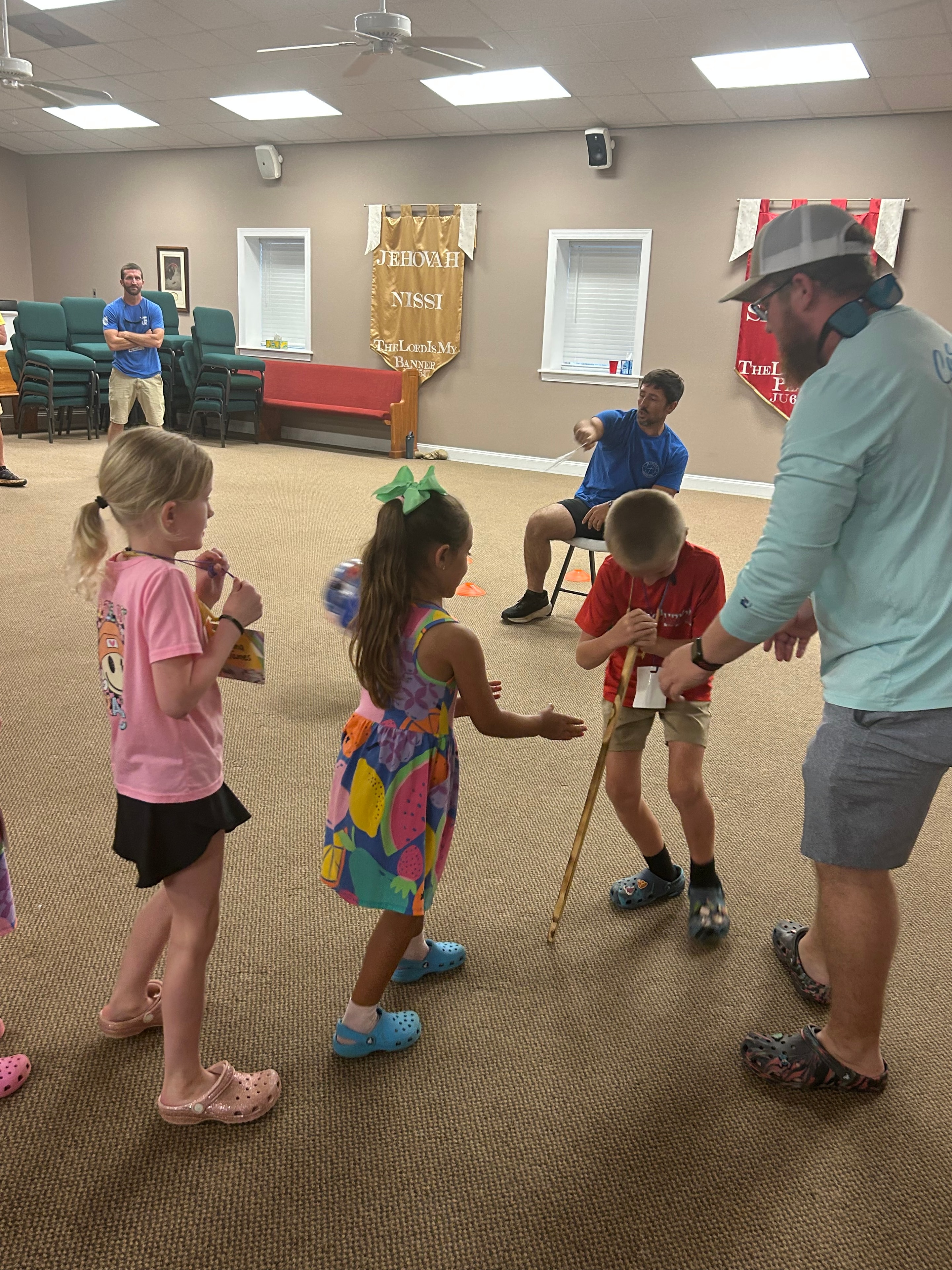 Children and leaders in a relay activity at VBS 2026