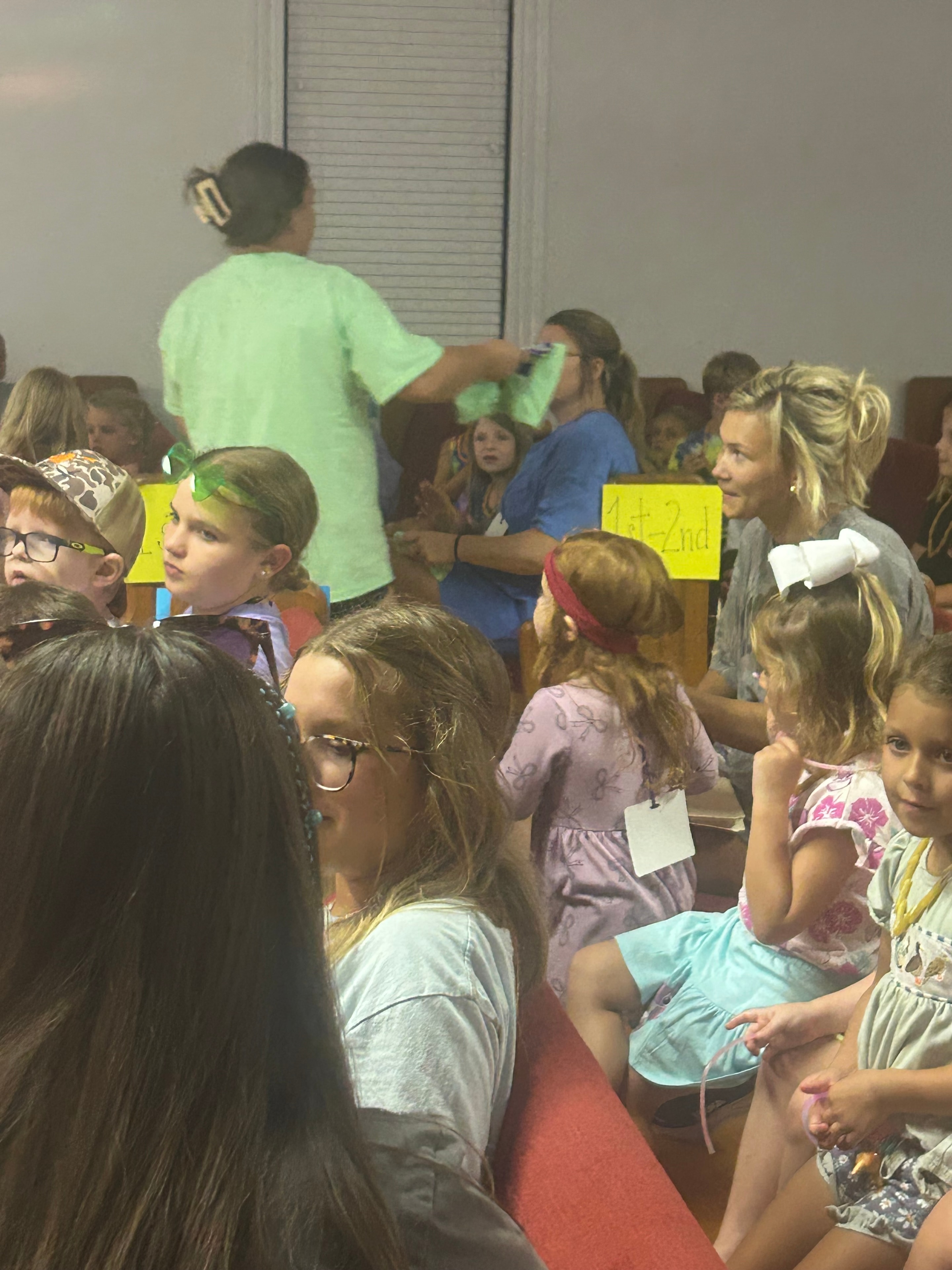 Children gathered around a table during a VBS 2026 classroom activity