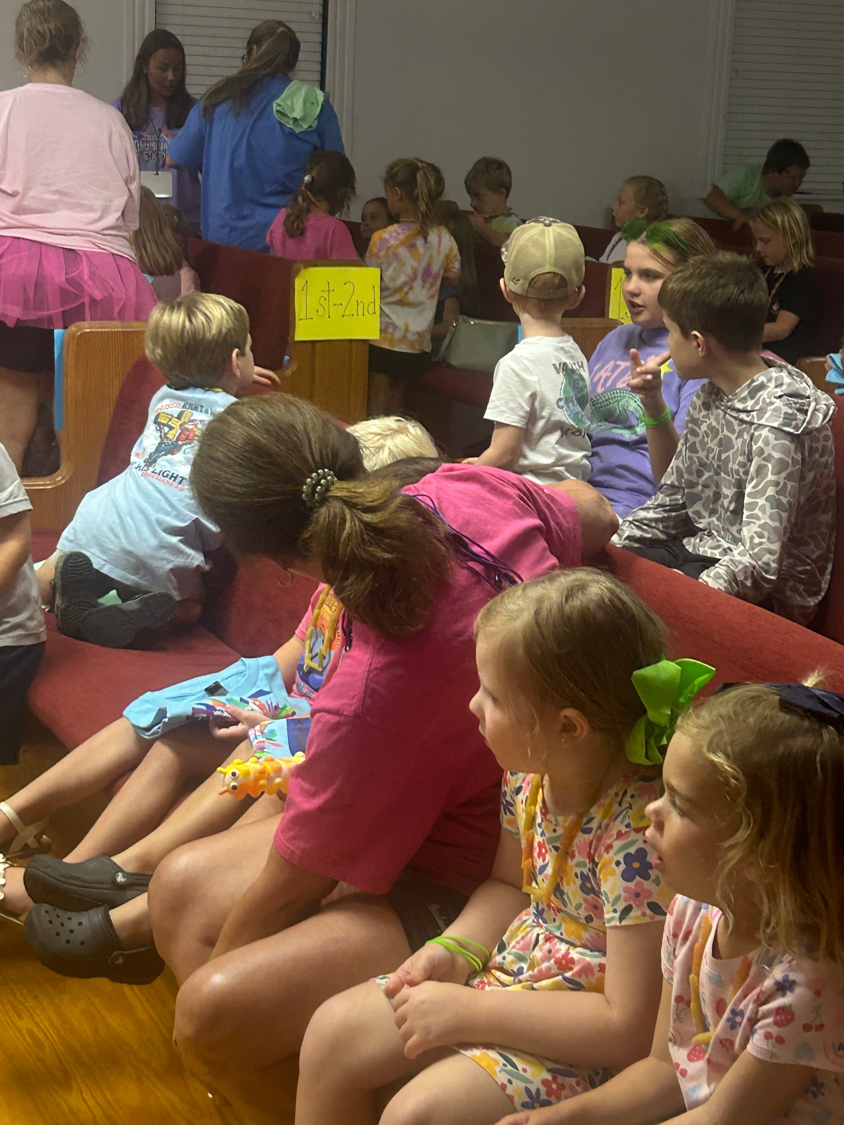 Children seated in pews during a VBS 2026 group session