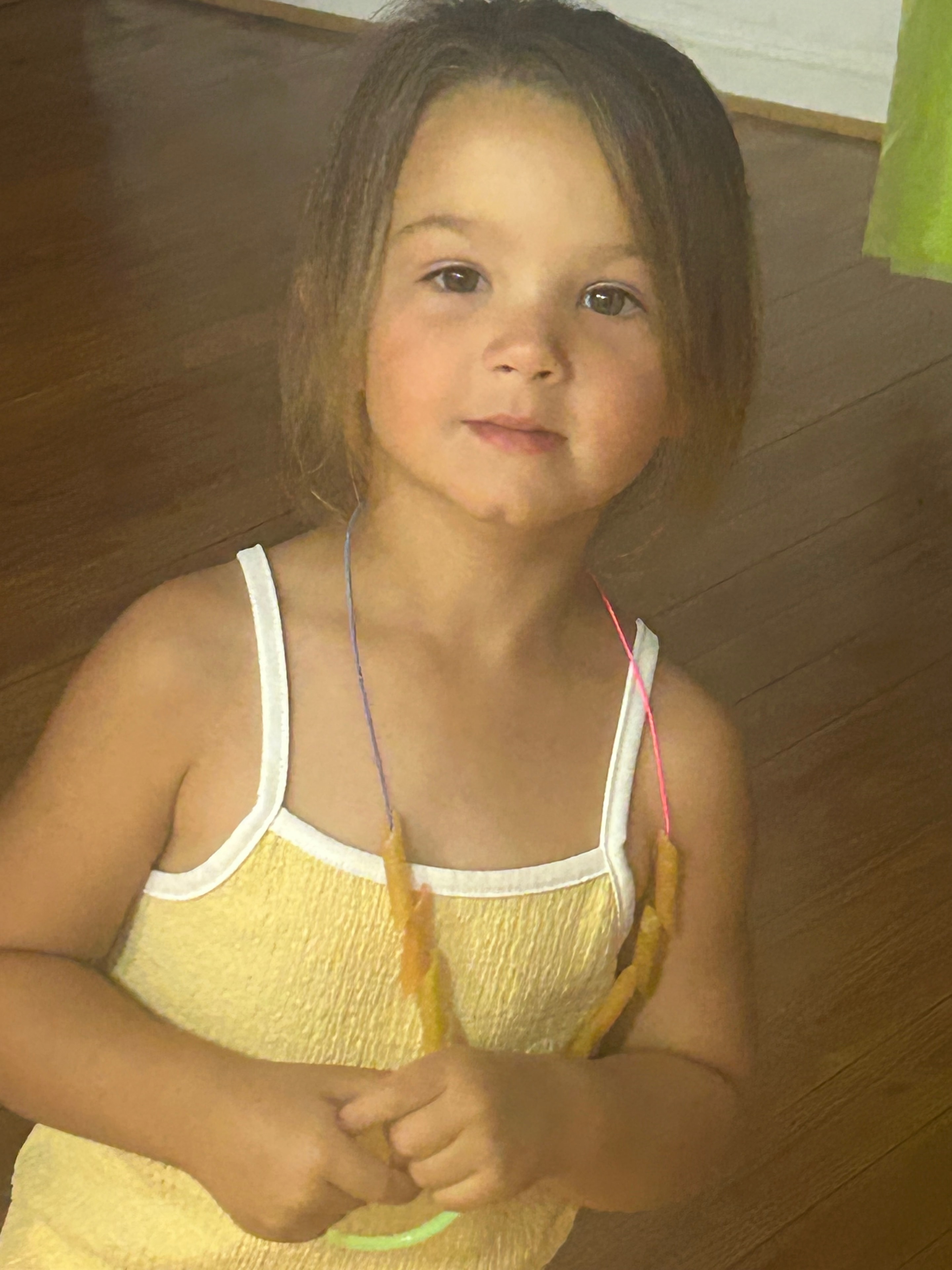 Young girl working on a craft necklace at VBS 2026