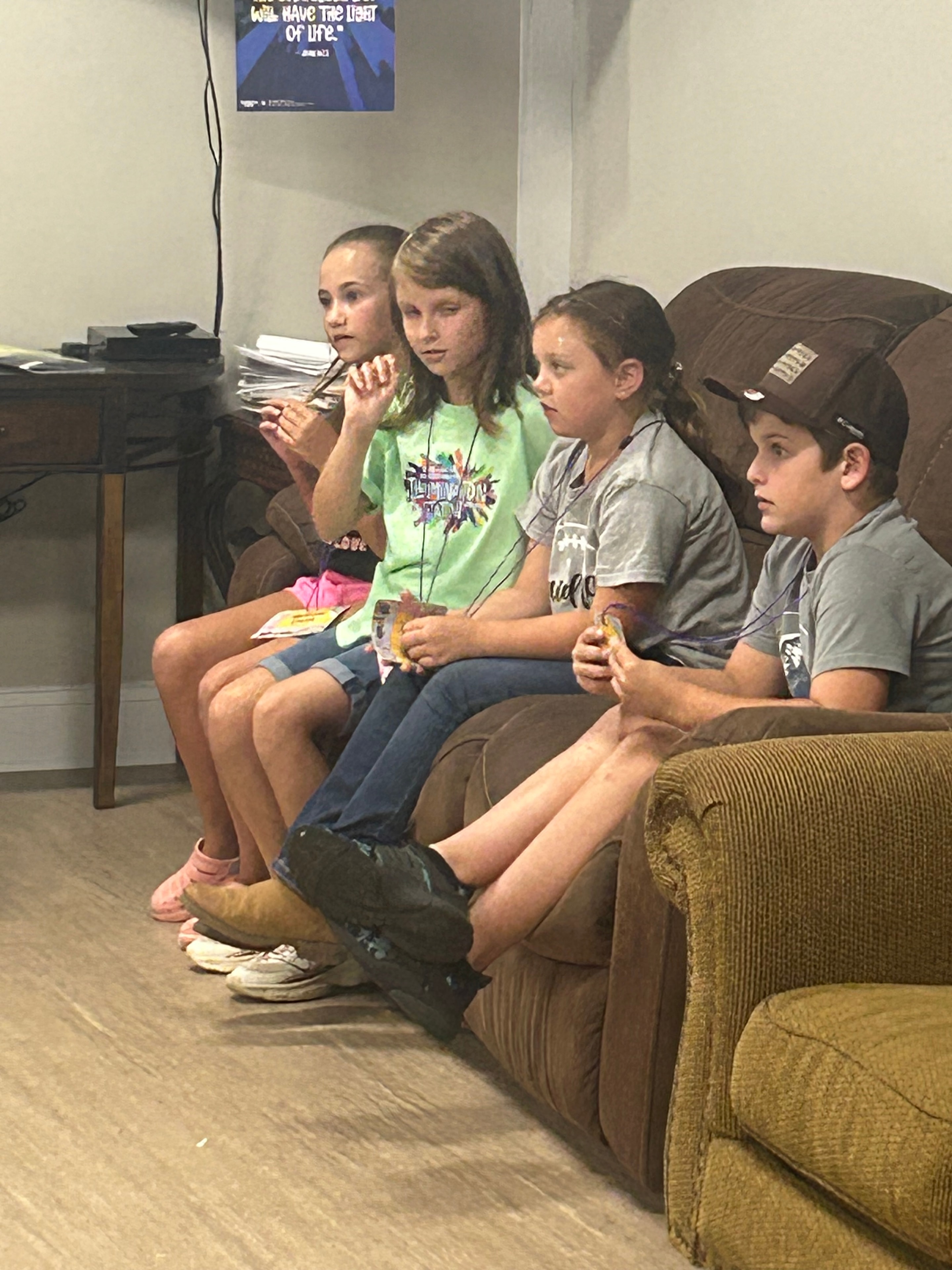 Children relaxing on a couch during a break at VBS 2026