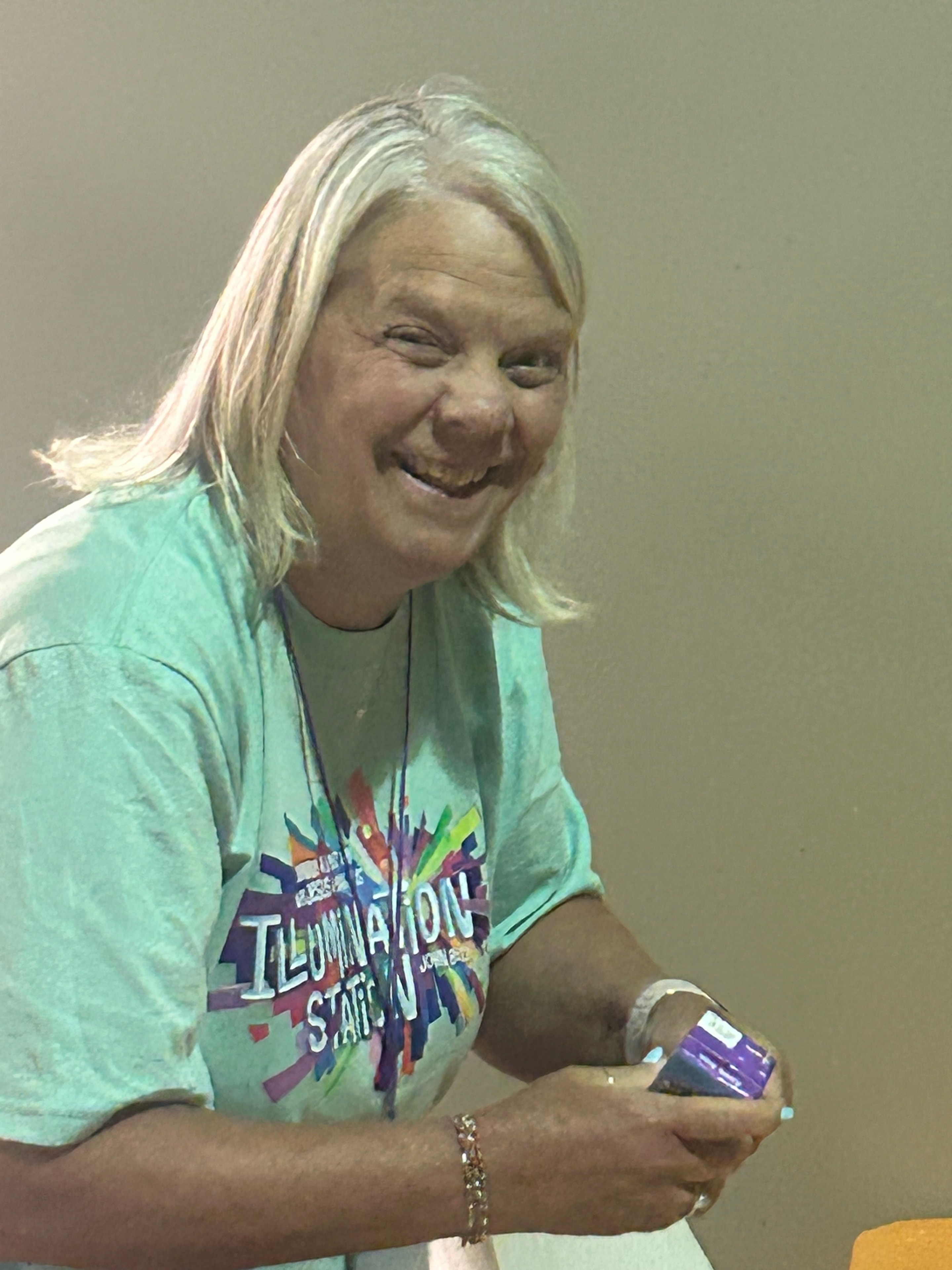 VBS volunteer in Illumination shirt laughing during VBS 2026