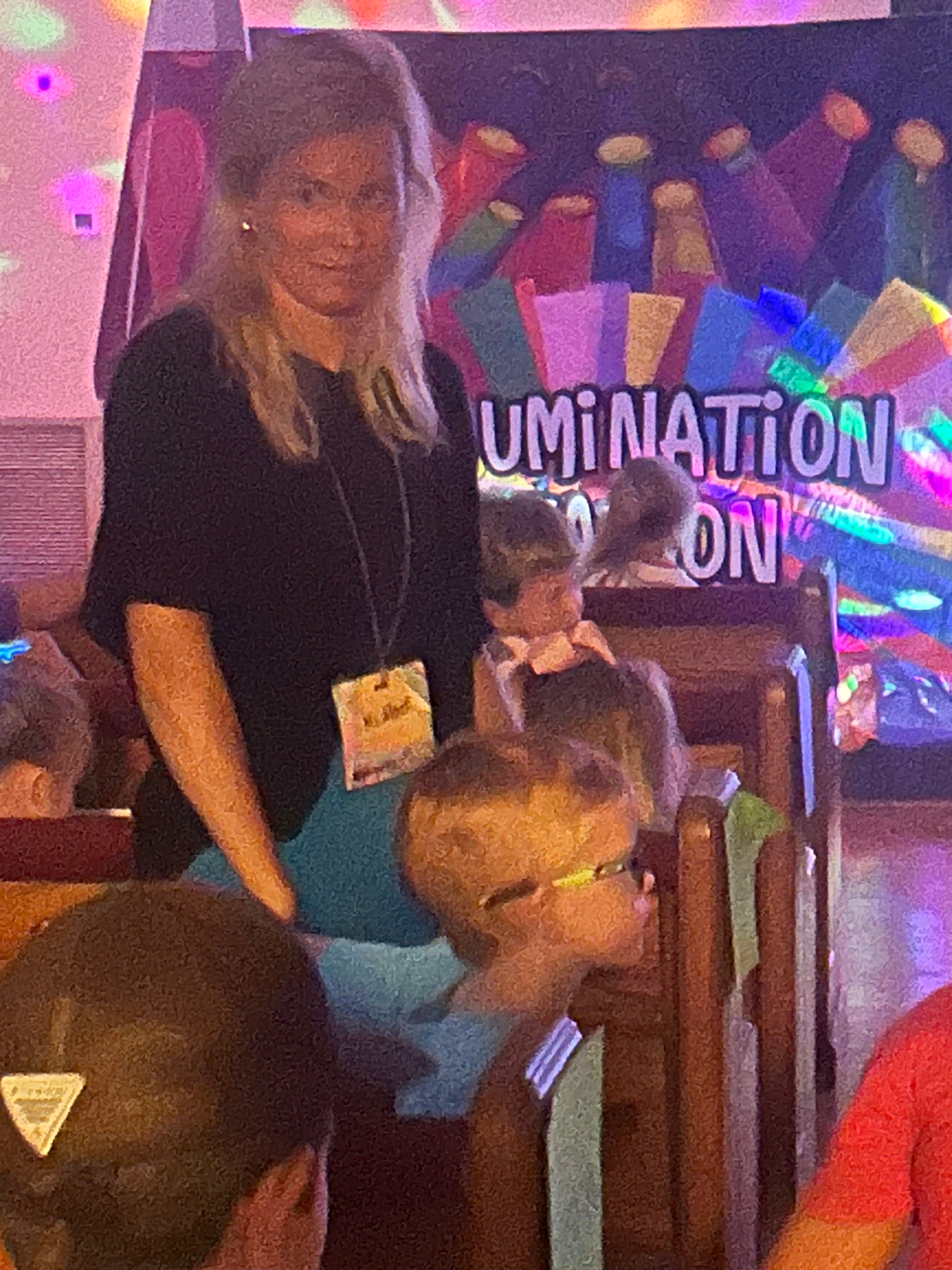 VBS volunteers and children near the Illumination station display