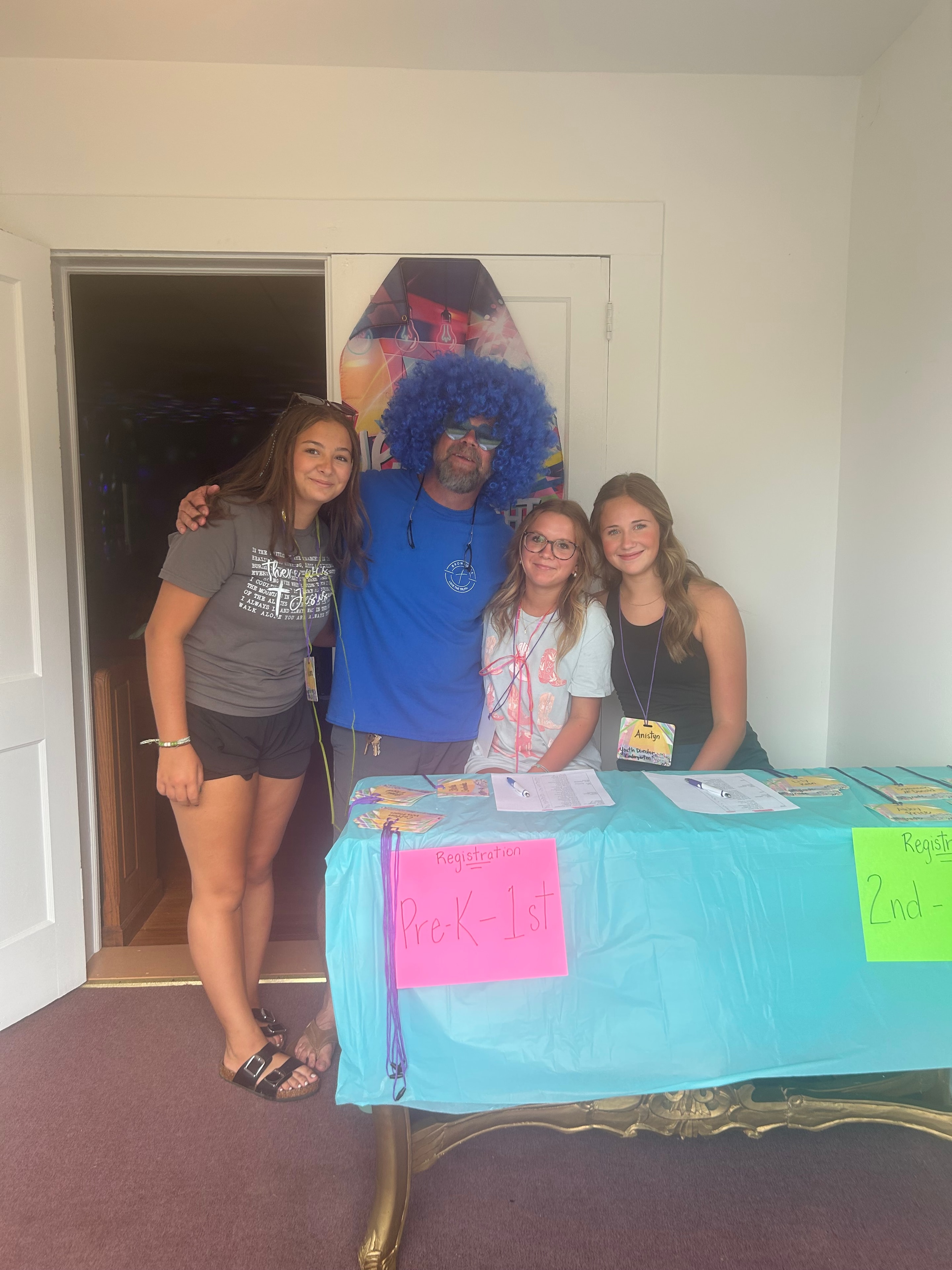 VBS registration team posing at the check-in table