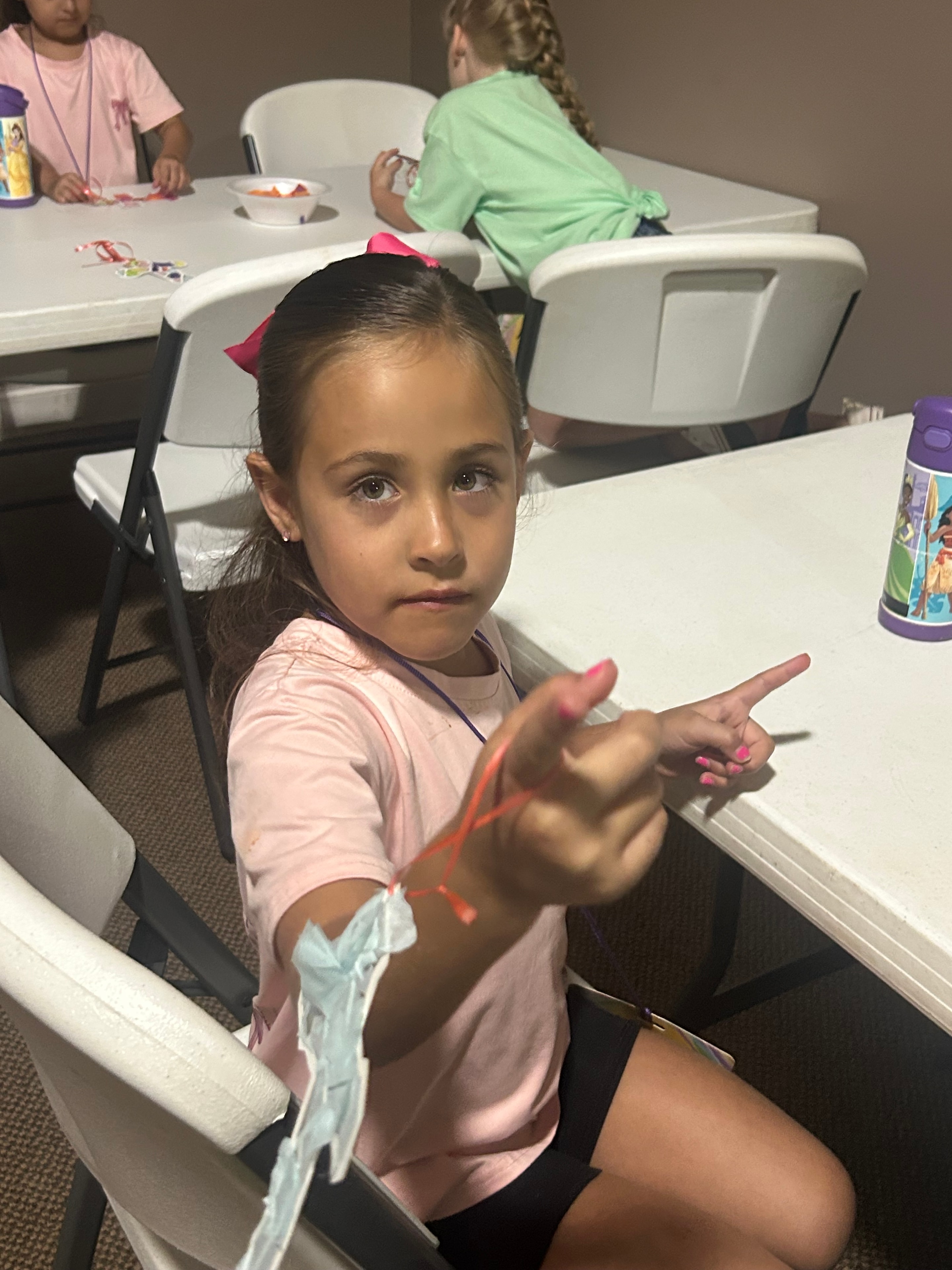 Child in blue cap at the Arts and Crafts station during VBS 2026