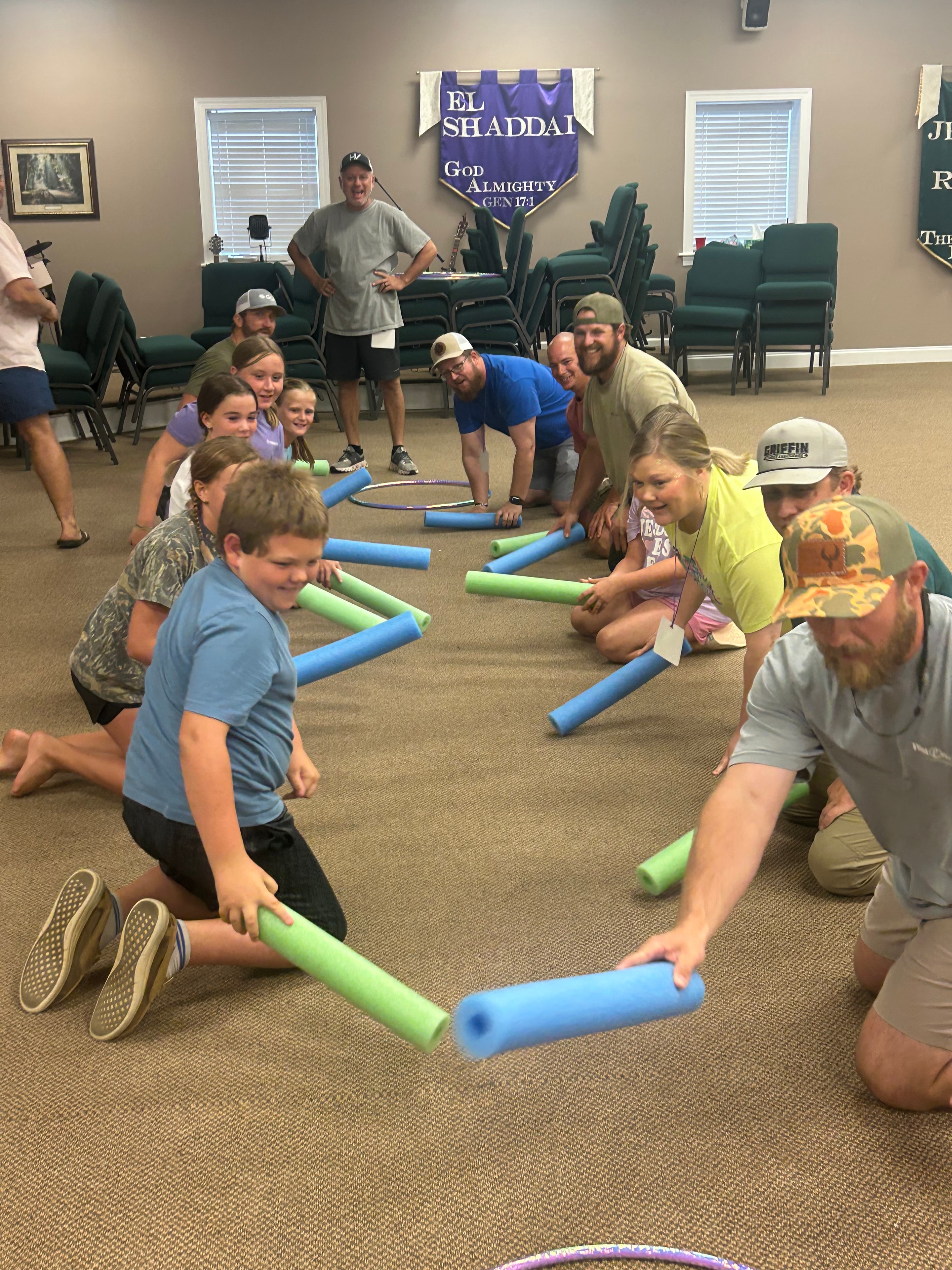 Group of children and adults playing pool noodle games at VBS 2026